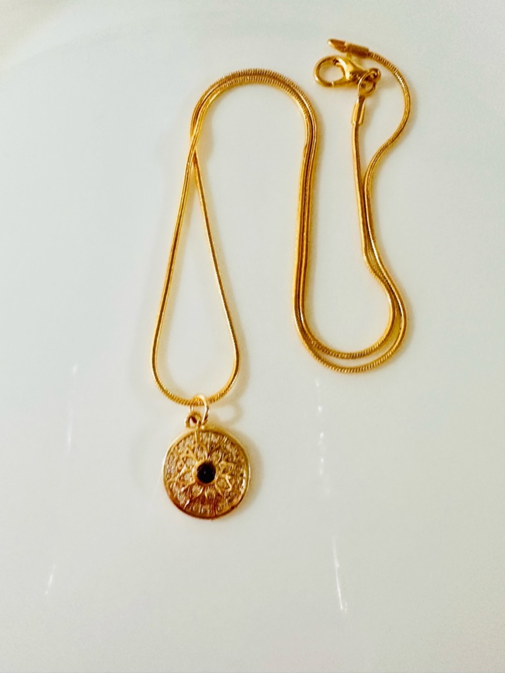 Gold Pendant Necklace with Black Stone.